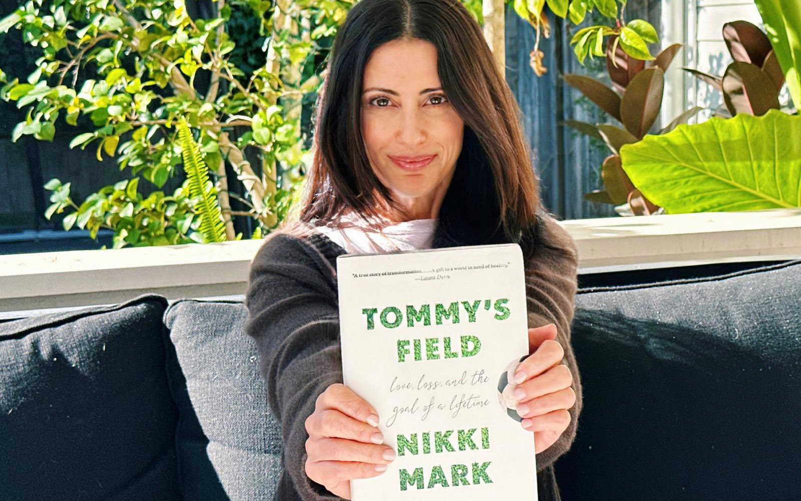 Nikki Mark with her book, Tommy's Field