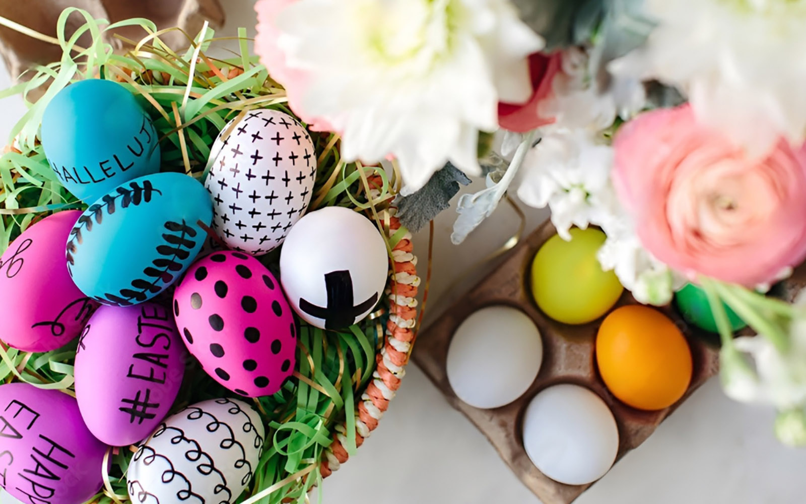 Colorful Easter eggs and spring flowers arrangement.